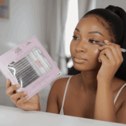 DIY Cluster Lash Kit Woman applying DIY cluster lashes using EVARA Lash Kit at vanity