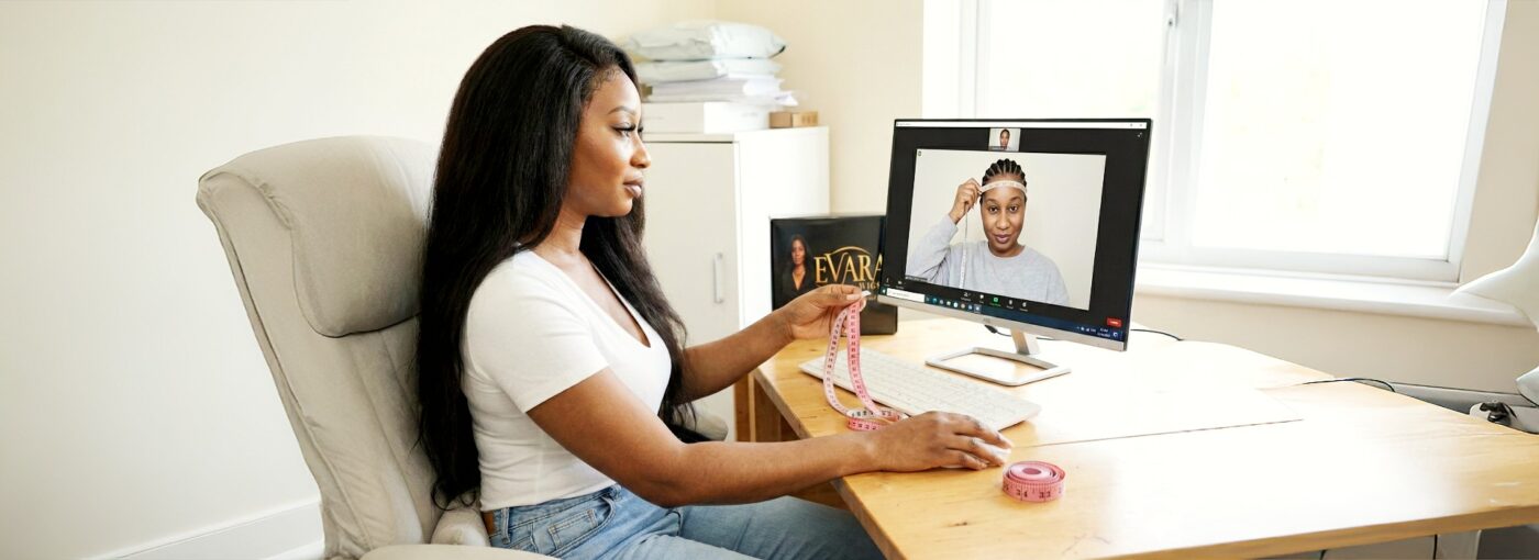 Shaurice founder of Evara Wigs guiding client through head measurements during personalized video consultation